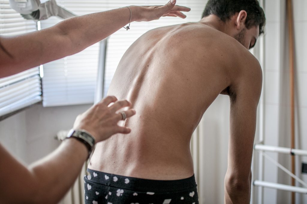 orthopedic-physiotherapist-check-body-growth-of-yo-PV2KGTU