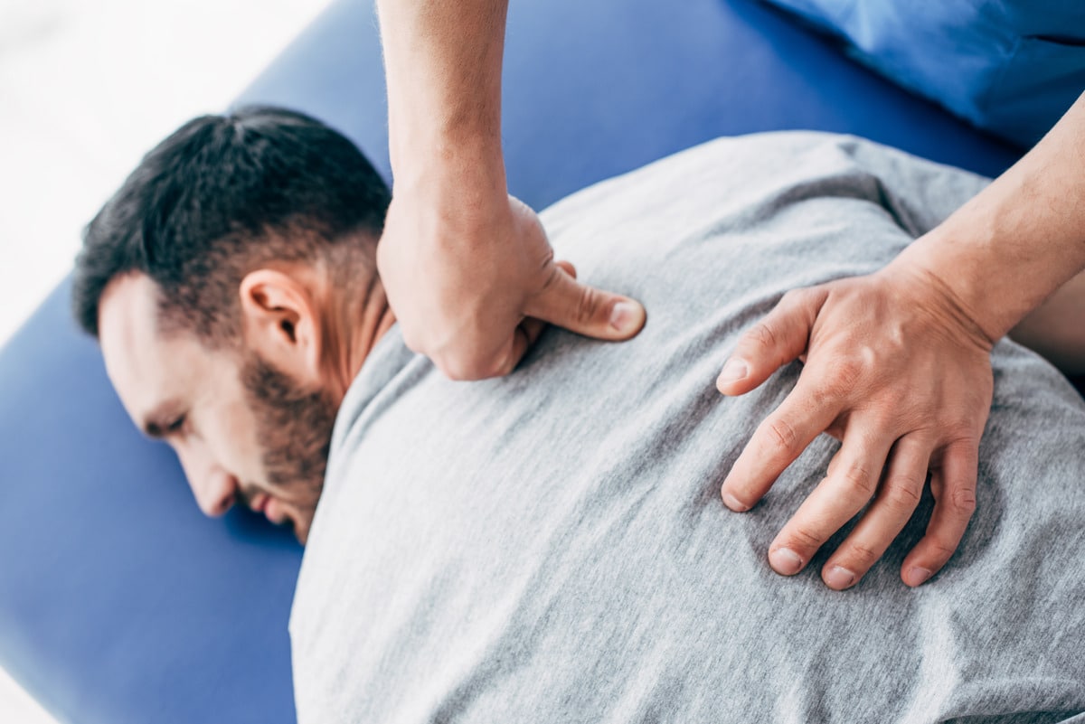 physiotherapist-massaging-back-of-man-lying-on-mas-2023-11-27-05-18-02-utc Chiro care2